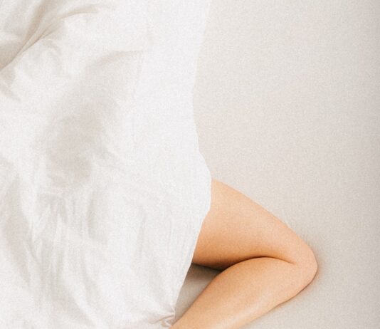 “하루 종일 앉아 있는 당신, 혈관 건강 괜찮나요?” a person laying in a bed with a white sheet