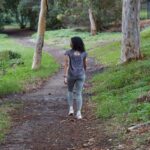 돌봄보다 ‘셀프케어’… 일상 속 건강 지키는 소소한 루틴 인기 a woman is walking down a path in the woods