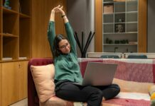 근육 건강, 생활 속에서 실천하는 새로운 트렌드 a woman sitting on a couch using a laptop