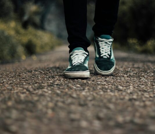 “나를 돌보는 일상이 정신건강을 바꾼다” a person standing on a gravel road with their shoes on